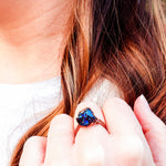 Load image into Gallery viewer, Peacock Ora Ring in Antique Copper top view shown on models hand - BellaChel Jeweler
