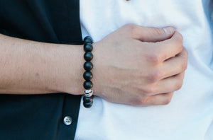 Real 12mm Shungite Bead Stretch Bracelet with metal alloy bead - close-up view on a model - BellaChel Jeweler