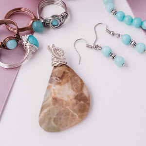 Laguna Collection - several Larimar Rings, Angelite Bracelet and matching earrings, and Fossil Agate Pendant close up picture - items sold separately - BellaChel Jeweler 