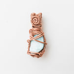 Load image into Gallery viewer, Laguna Collection - Larimar Pendant weaved in Antique Copper - designed to be worn on both sides - back side view - BellaChel Jeweler
