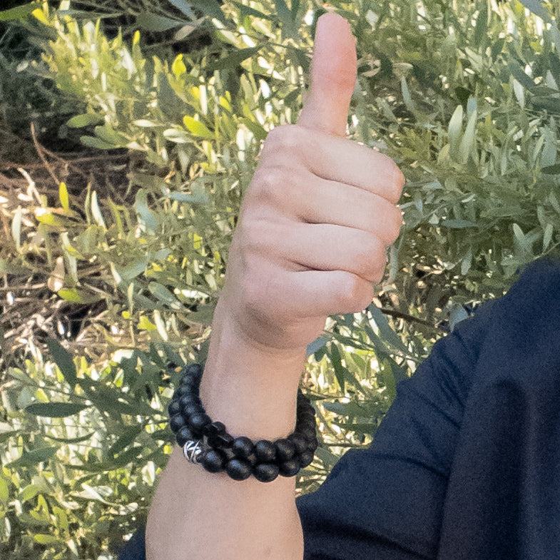 Viking Collection - Real Shungite Bracelet with Cross, 10mm bead - on a model giving a thumbs up, wearing 2 Shungite bracelets, sold separately - BellaChel Jeweler