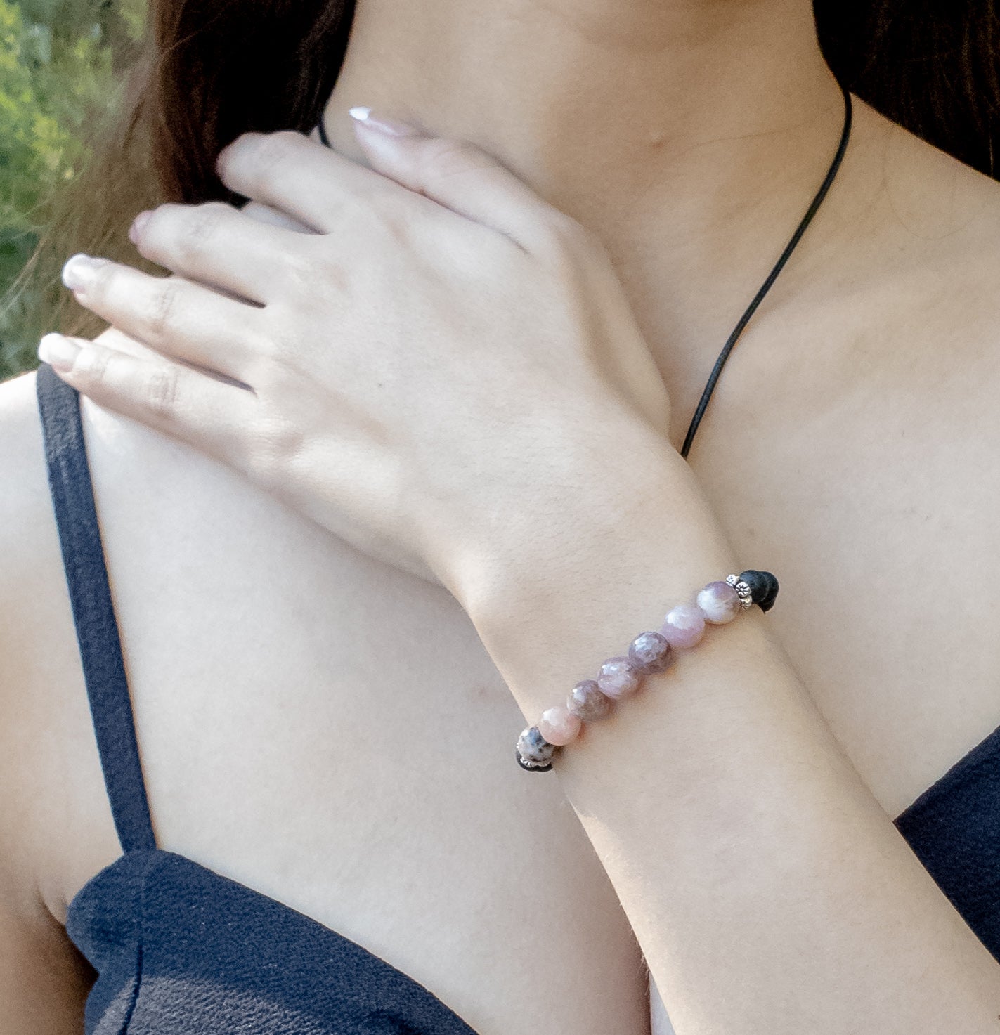 Powerful Lavender Quartz and Lava Stone Bracelet shown on a model - BellaChel Jeweler