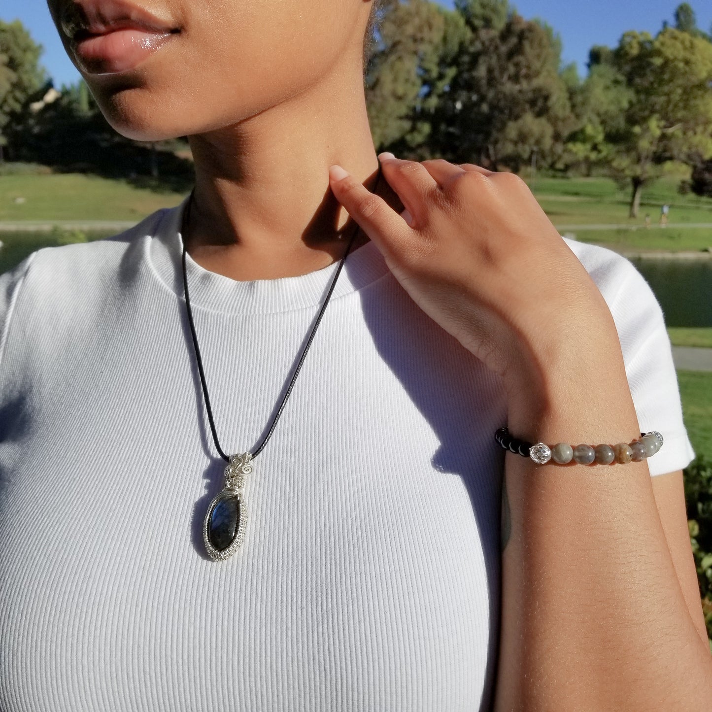 Elegant Labradorite Pendant weaved in Sterling Silver on a model - BellaChel Jeweler