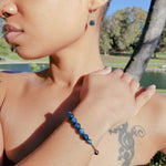 Load image into Gallery viewer, Stunning Blue Tiger Eye Bracelet with Silver Accents shown with matching earrings on a model, sold separately - BellaChel Jeweler
