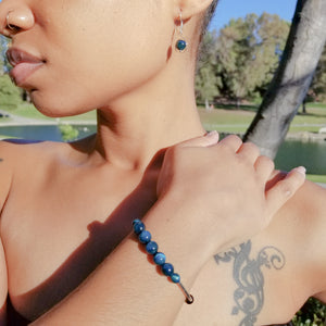 Stunning Blue Tiger Eye Bracelet with Silver Accents shown with matching earrings on a model, sold separately - BellaChel Jeweler