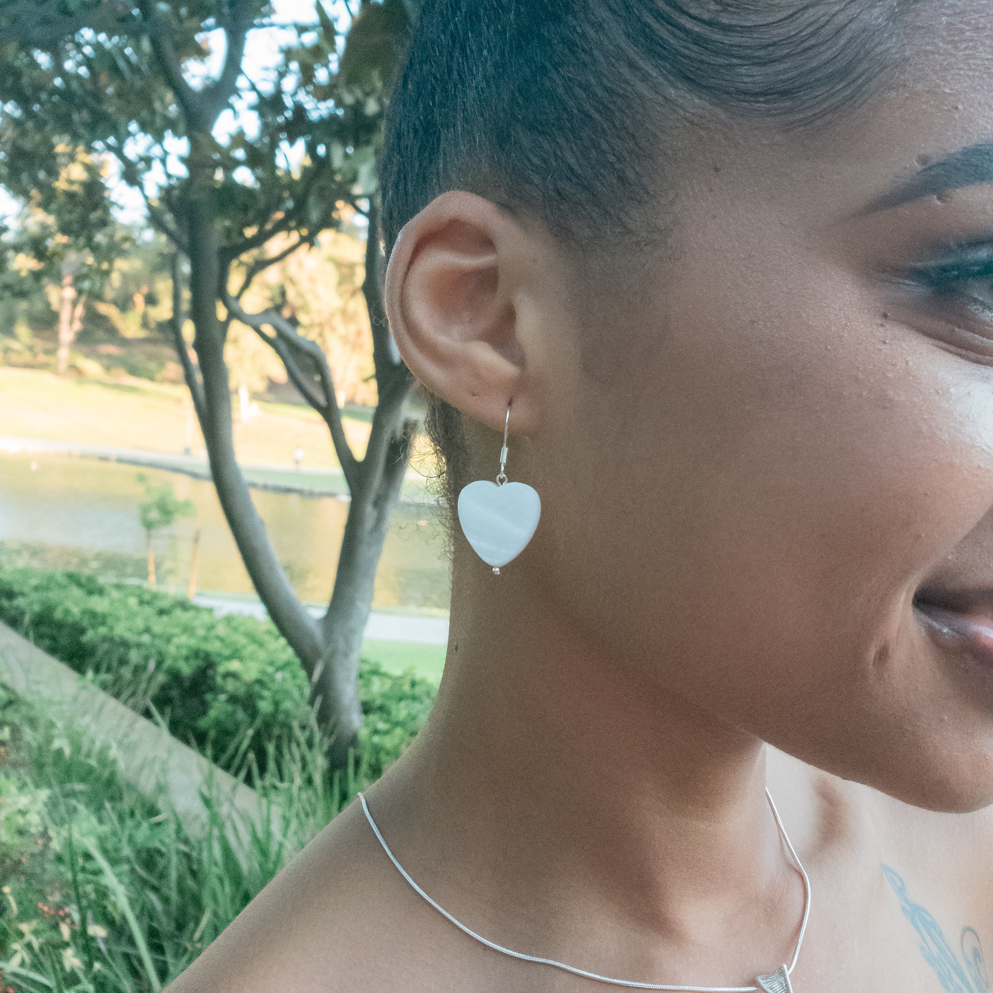 Celestial Collection - Mother of Pearl Heart Shape Earrings on a model - front view - BellaChel Jeweler