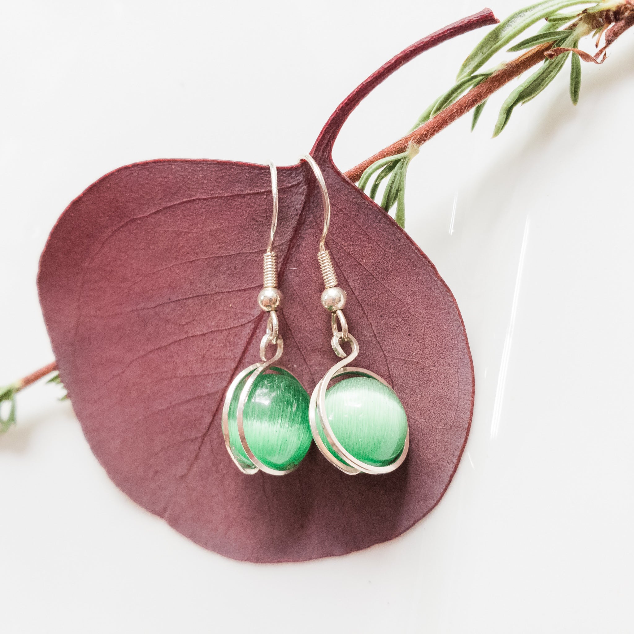 Rio Collection - Green Cats Eye Earrings Wrapped in Sterling Silver - Close-up view - BellaChel Jeweler