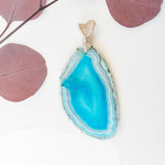 Cargar imagen en el visor de la galería, Rio Collection - Striking Blue Sliced Geode Agate Pendant close up view - BellaChel Jeweler
