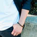 Charger l&#39;image dans la galerie, Tiger Eye Cushion Bead &amp; Lava Stone Bracelet, up close view on a male model - BellaChel Jeweler
