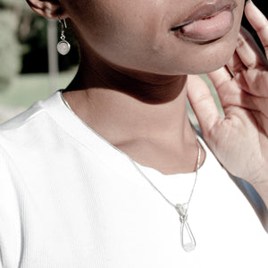 Natural Rose Quartz Pendant Necklace with Sterling Silver Chain and Rose Quartz Earrings on a model - BellaChel Jeweler